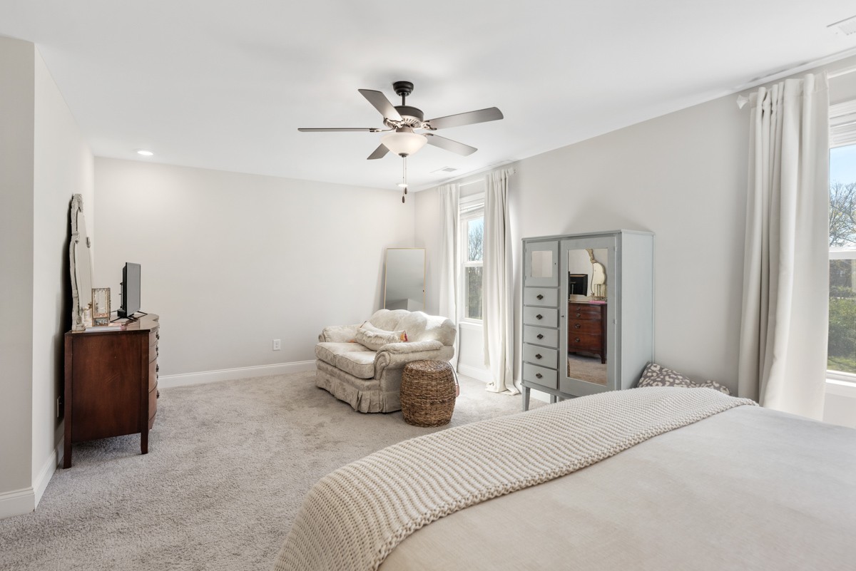 235 Grandstand Boulevard Gallatin, TN 37066 - Photo 15 of 26 a bedroom with a bed and ceiling fan