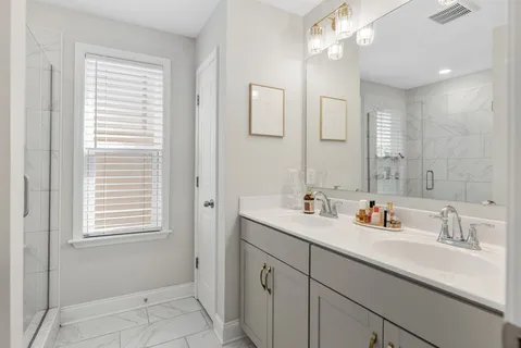 a bathroom with a sink double vanity and a mirror