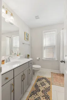 a spacious bathroom with a granite countertop sink and a mirror