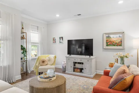 a living room with furniture a fireplace and a flat screen tv