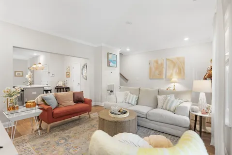 a living room with furniture a rug and a large window