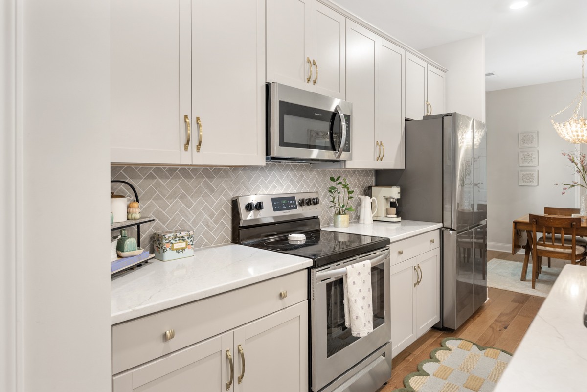235 Grandstand Boulevard Gallatin, TN 37066 - Photo 9 of 26 a kitchen with stainless steel appliances granite countertop a stove a sink and a refrigerator