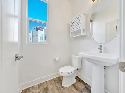 a bathroom with a sink toilet and a mirror