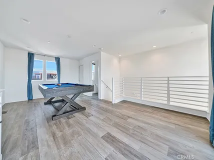 a view of a room with wooden floor and a window