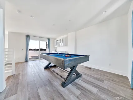 a living room with a table and wooden floor