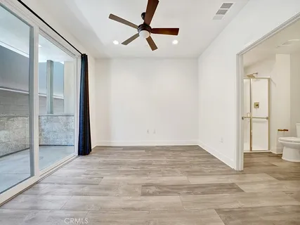 a view of a livingroom with a ceiling fan & entryway