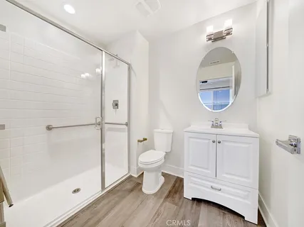 a bathroom with a toilet a sink and shower