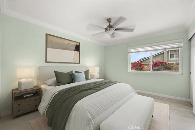 a bedroom with a bed and a painting on the wall