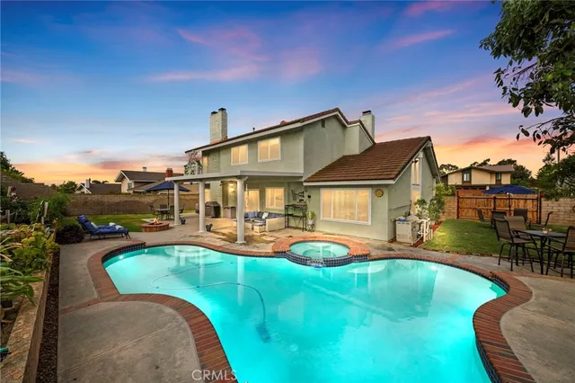 an aerial view of a house with swimming pool garden and patio