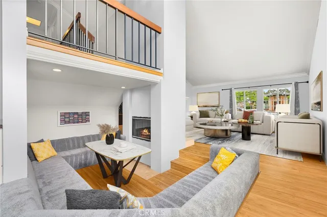 a living room with furniture fireplace and a table