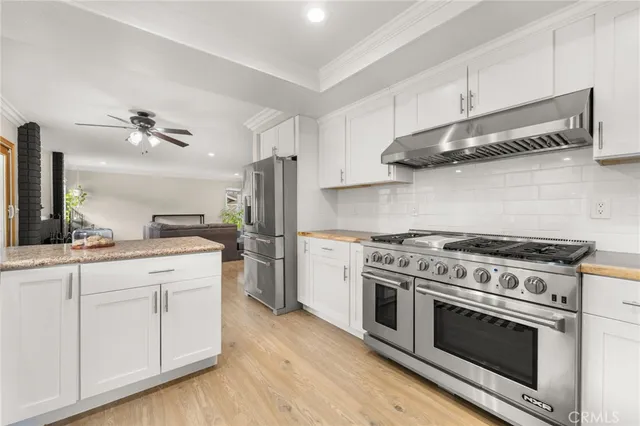 a kitchen with stainless steel appliances a stove and a refrigerator