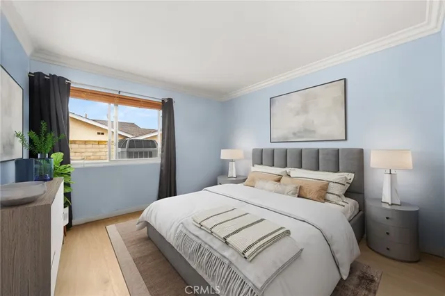 a bedroom with a bed and a large window