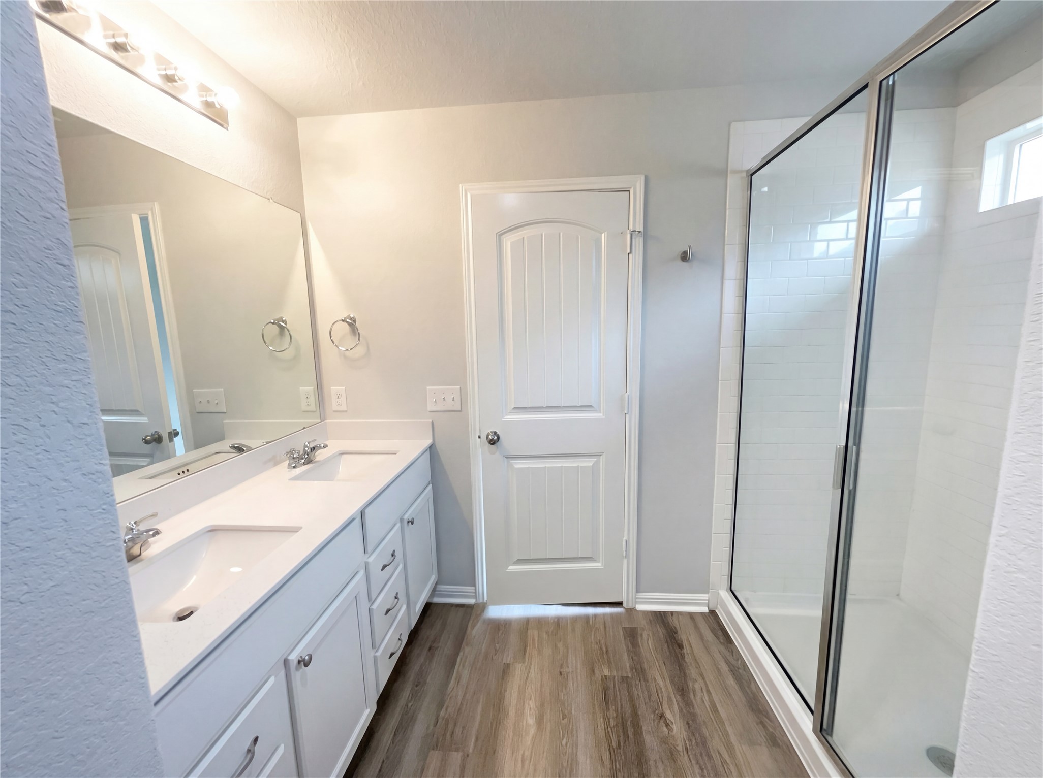 413 Dubina Avenue Georgetown, TX 78626 - Photo 11 of 22 Full bath with a shower stall, double vanity, and dark wood-type flooring
