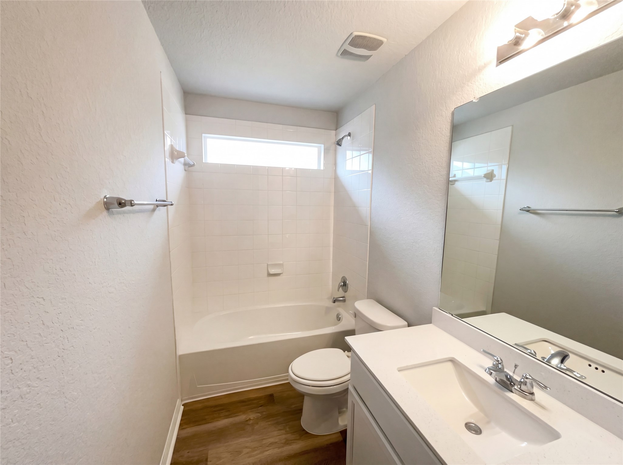 413 Dubina Avenue Georgetown, TX 78626 - Photo 13 of 22 Full bathroom with a textured wall, shower / washtub combination, vanity, dark wood-style floors, and a textured ceiling