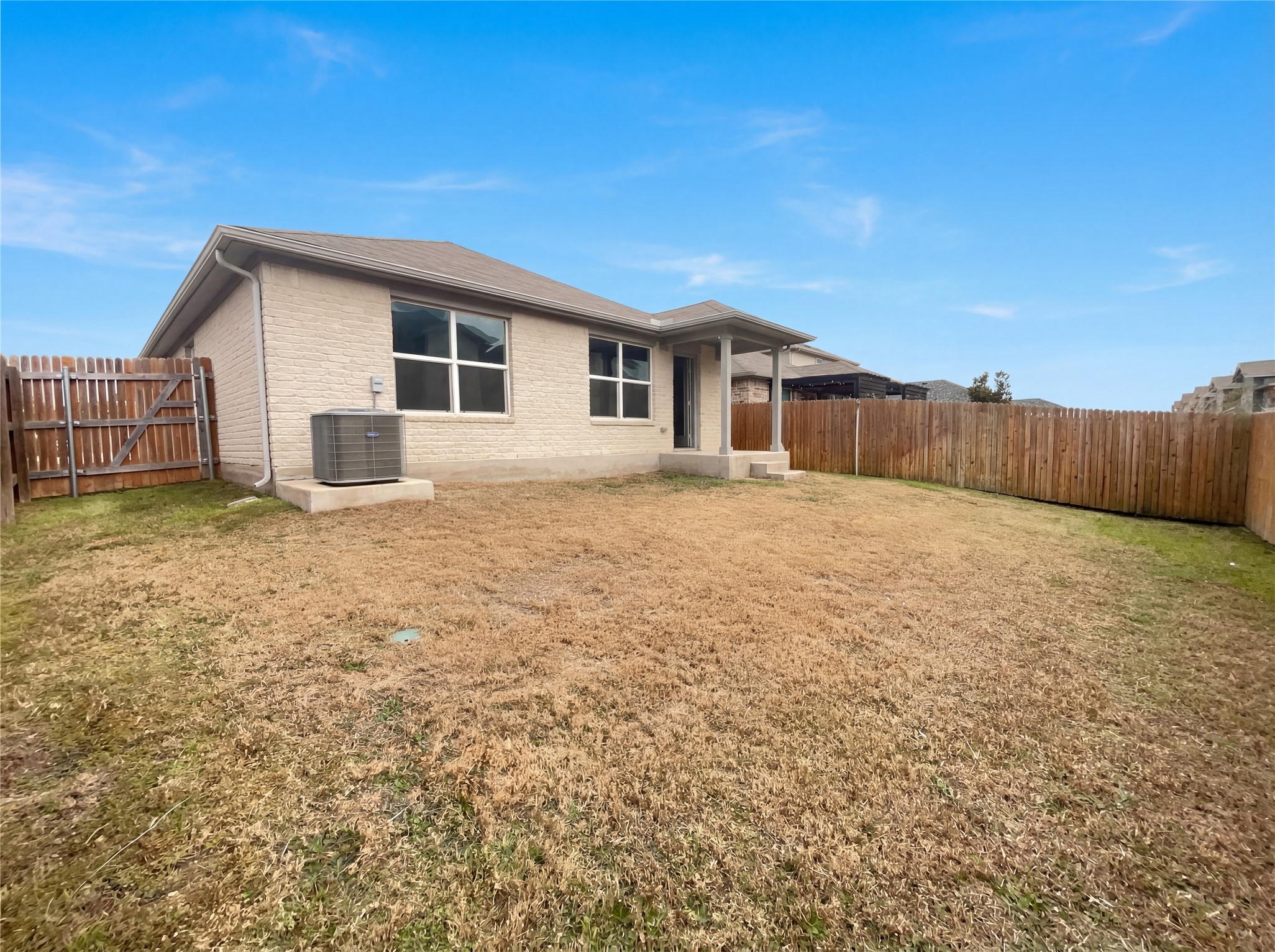 413 Dubina Avenue Georgetown, TX 78626 - Photo 20 of 22 Back of property with a fenced backyard, brick siding, and a gate