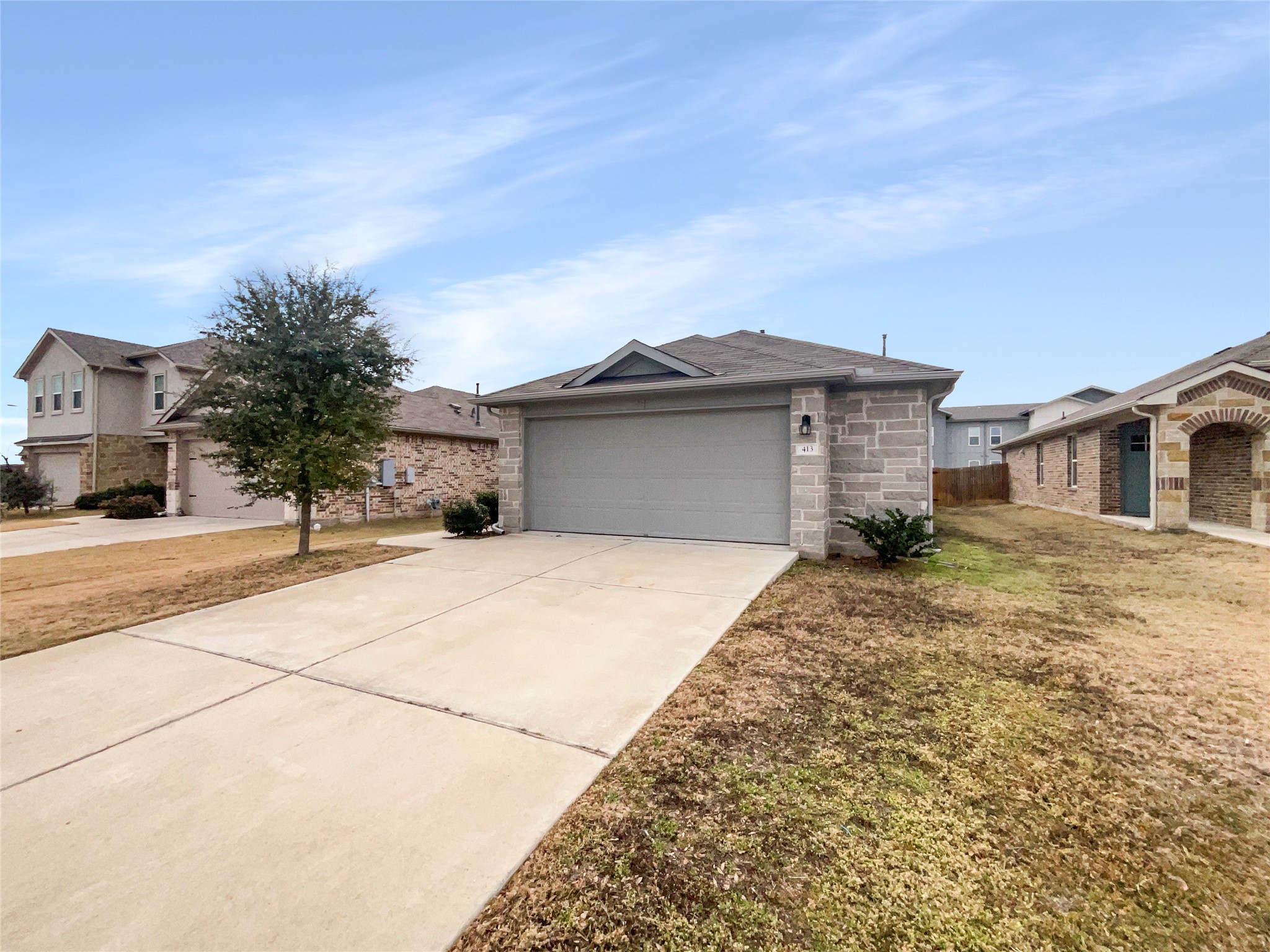 413 Dubina Avenue Georgetown, TX 78626 - Photo 21 of 22 Single story home with concrete driveway, stone siding, and an attached garage