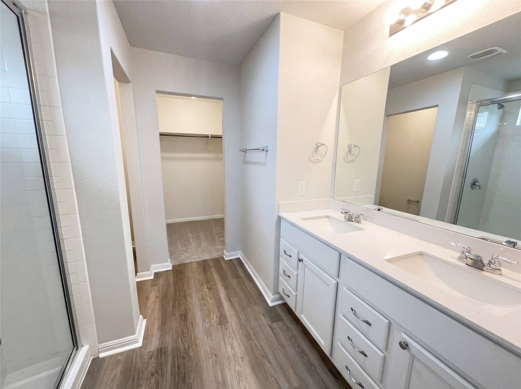 413 Dubina Avenue Georgetown, TX 78626 - Photo 9 of 22 Bathroom with a shower stall, double vanity, a walk in closet, and dark wood finished floors