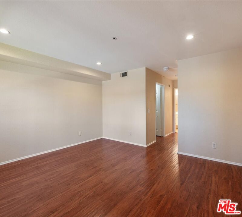 15114 Sherman Way, Unit 104 Van Nuys, CA 91405 - Photo 13 of 19 a view of an empty room with wooden floor