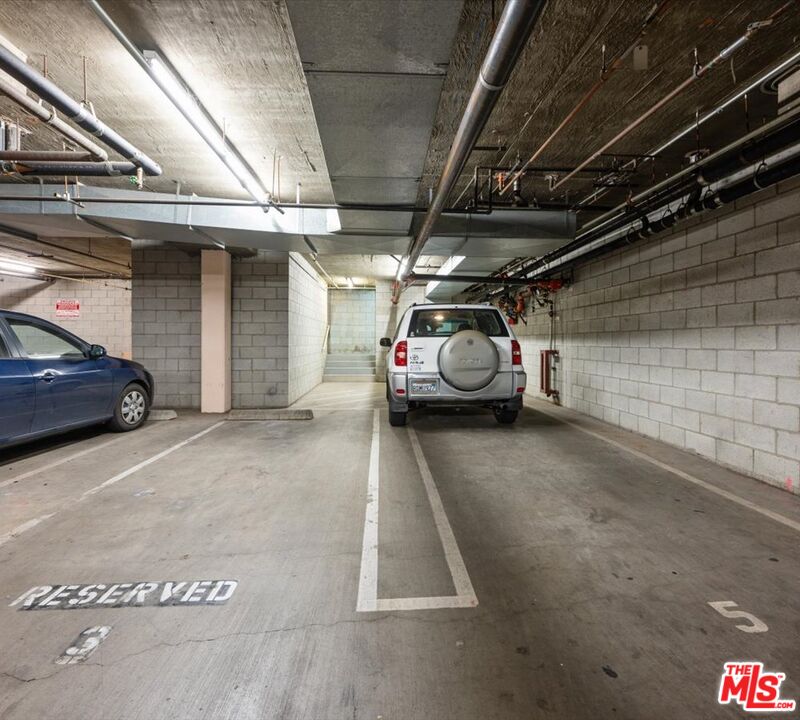 15114 Sherman Way, Unit 104 Van Nuys, CA 91405 - Photo 18 of 19 a view of parking garage with cars