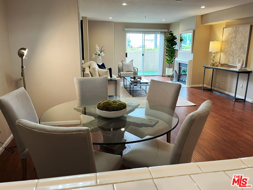 15114 Sherman Way, Unit 104 Van Nuys, CA 91405 - Photo 2 of 19 a living room with furniture a window and kitchen view