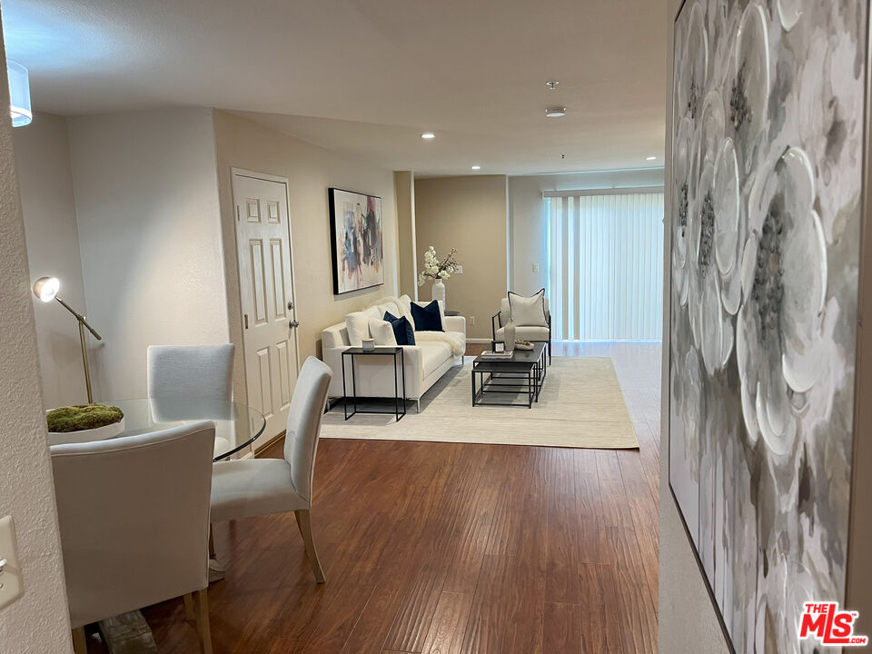 15114 Sherman Way, Unit 104 Van Nuys, CA 91405 - Photo 3 of 19 a living room with furniture and a wooden floor