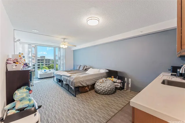 a spacious bedroom with a bed and a chandelier