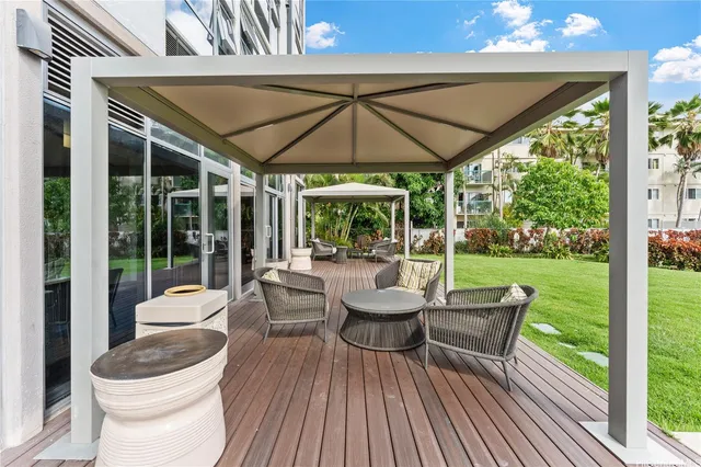 a view of a pool with outdoor seating