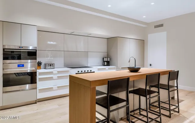 a kitchen with stainless steel appliances kitchen island granite countertop a sink and cabinets