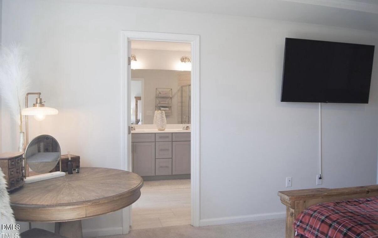 5006 Tura Street Raleigh, NC 27610 - Photo 18 of 32 a bathroom with a sink and a mirror