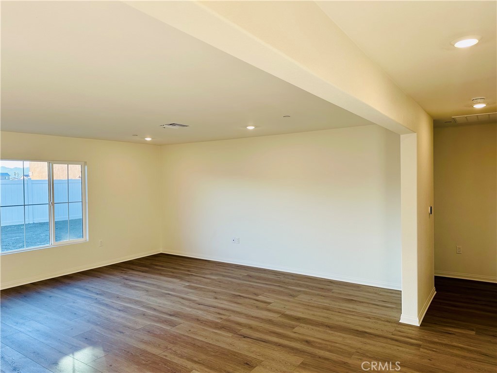 916 Runaway Trail San Jacinto, CA 92582 - Photo 15 of 23 wooden floor in an empty room with a window