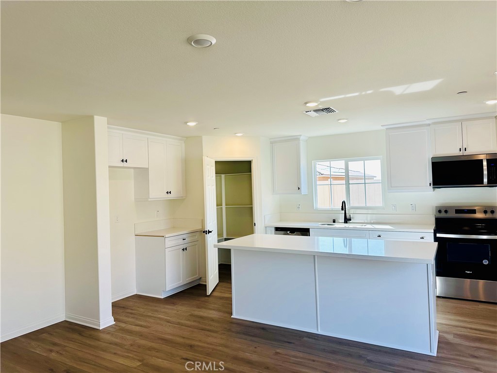 916 Runaway Trail San Jacinto, CA 92582 - Photo 3 of 23 a kitchen with a refrigerator and a sink