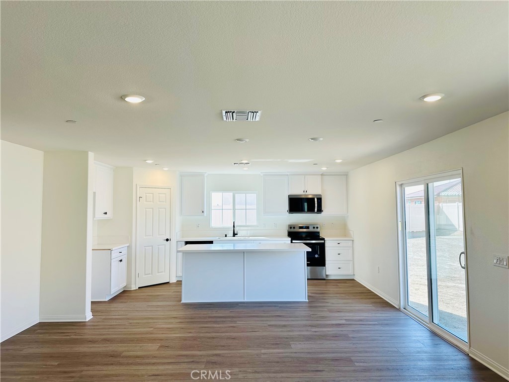916 Runaway Trail San Jacinto, CA 92582 - Photo 10 of 23 a view of kitchen with wooden floor and electronic appliances