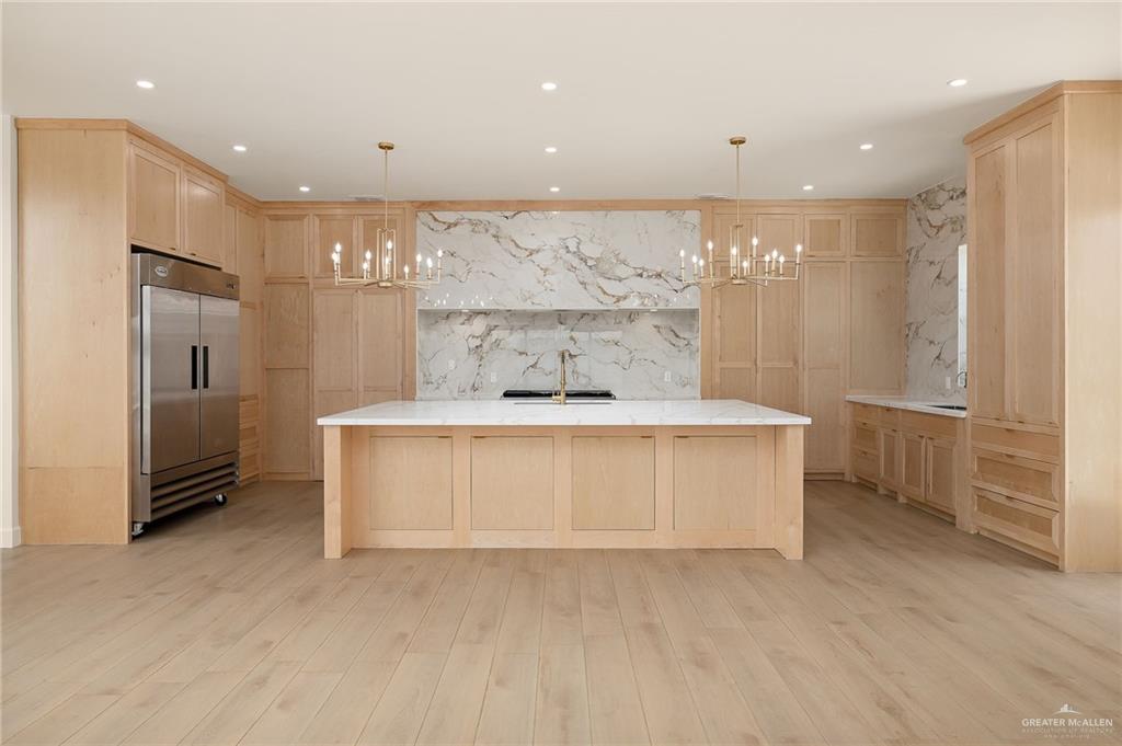 1215 Chelsea Drive Palmhurst, TX 78573 - Photo 12 of 30 a view of kitchen with stainless steel appliances granite countertop a stove a sink and a refrigerator