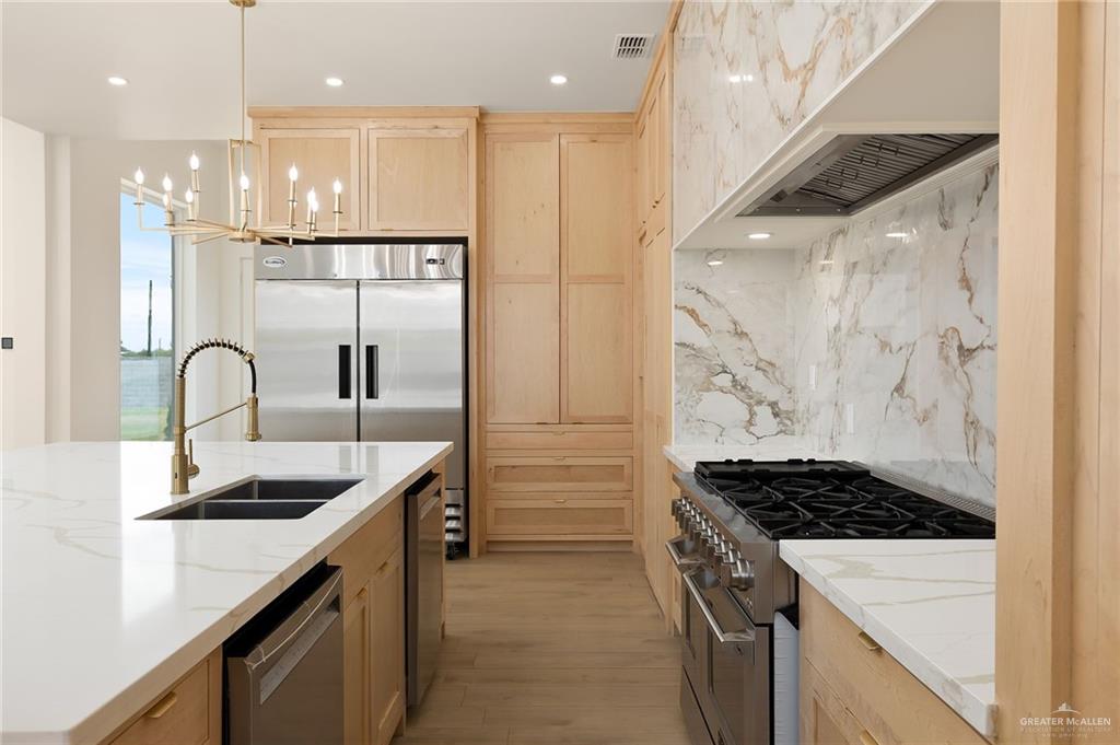 1215 Chelsea Drive Palmhurst, TX 78573 - Photo 15 of 30 a kitchen with stainless steel appliances granite countertop a sink and a refrigerator