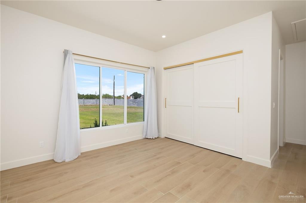 1215 Chelsea Drive Palmhurst, TX 78573 - Photo 17 of 30 an empty room with windows