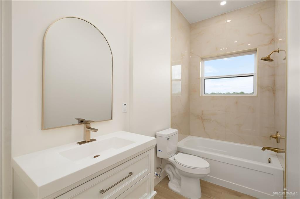 1215 Chelsea Drive Palmhurst, TX 78573 - Photo 20 of 30 a bathroom with a sink a toilet and shower