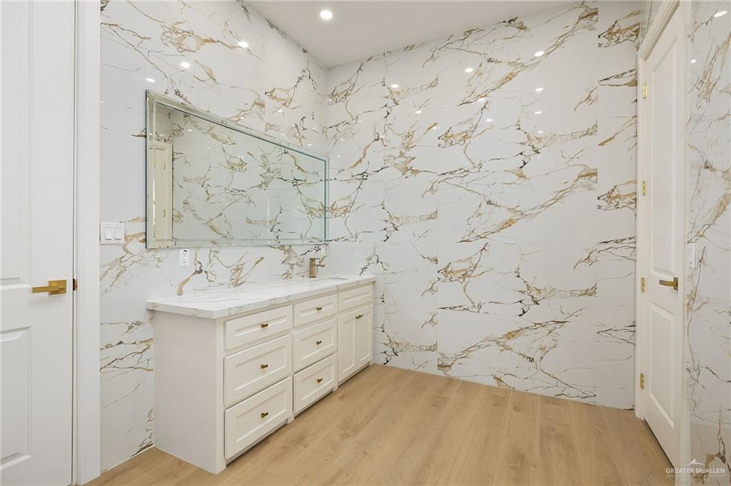1215 Chelsea Drive Palmhurst, TX 78573 - Photo 22 of 30 a bathroom with a sink mirror and a shower
