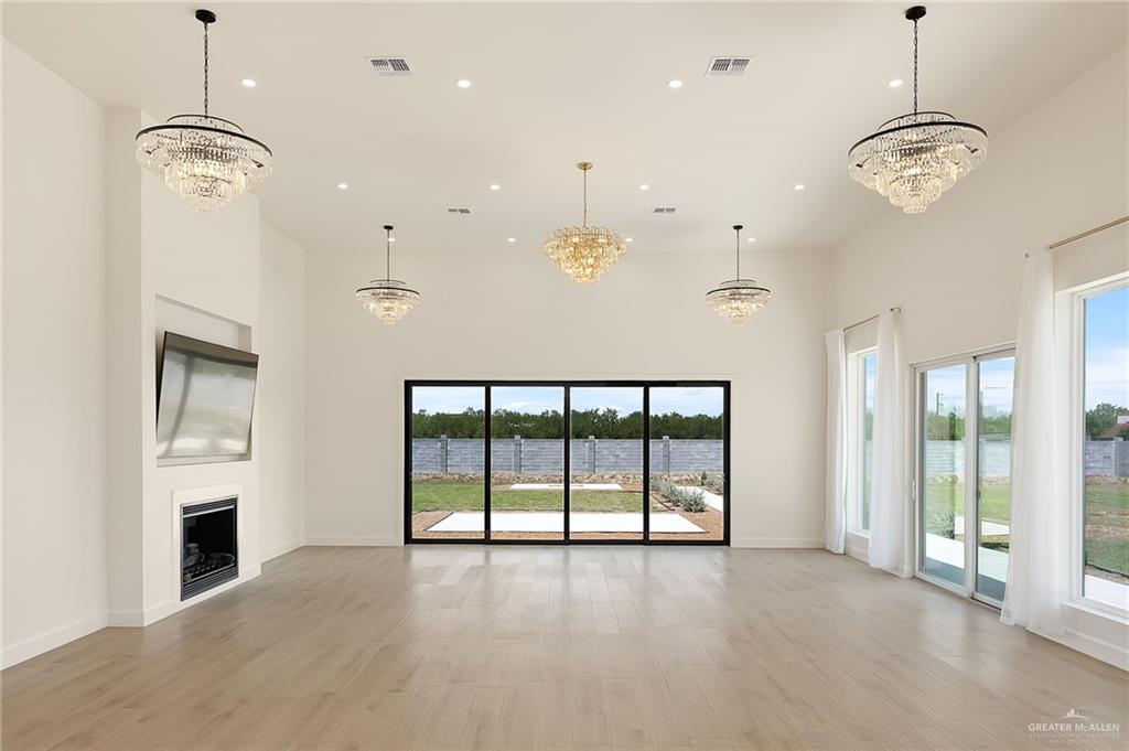 1215 Chelsea Drive Palmhurst, TX 78573 - Photo 8 of 30 a view of an empty room with a fireplace and a window