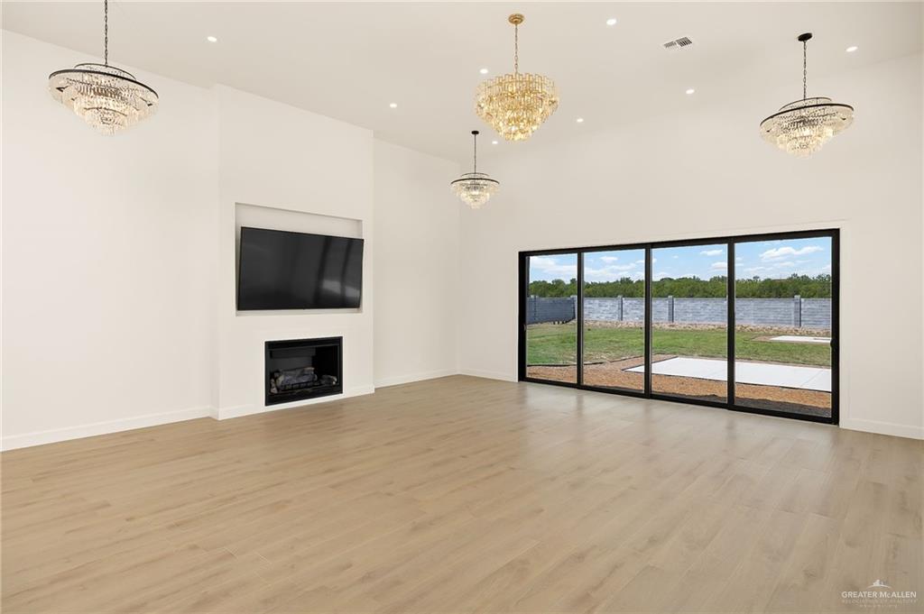 1215 Chelsea Drive Palmhurst, TX 78573 - Photo 9 of 30 a view of an empty room with a fireplace and a window