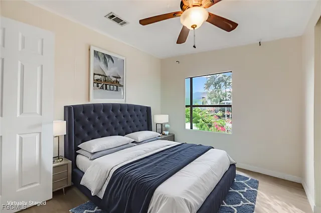 a bedroom with a large bed and a chandelier