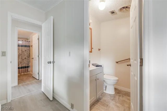 a bathroom with a sink a toilet and vanity