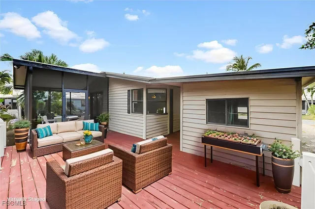 a view of backyard with seating space and trees