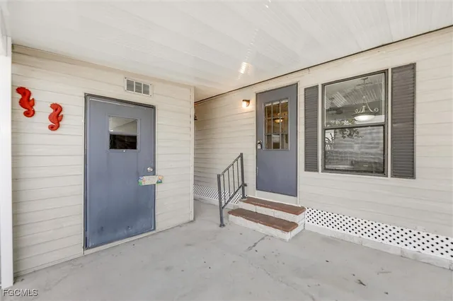 a kitchen with stainless steel appliances a stove a sink a dining table and chairs