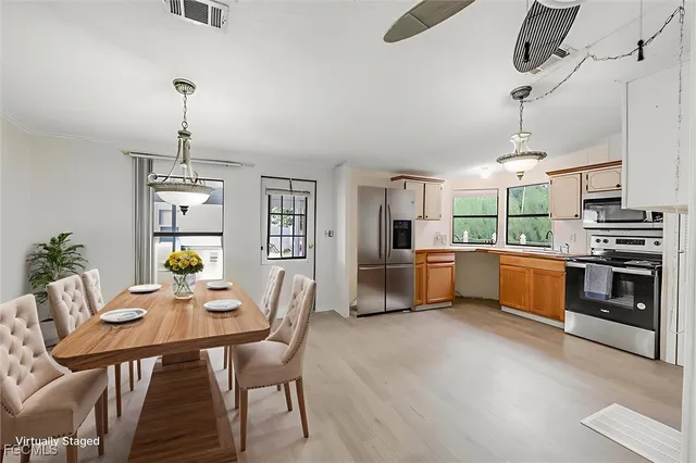 a view of a dining room with furniture window and wooden floor