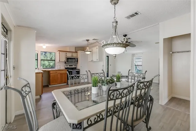 a dining room with furniture window and wooden floor