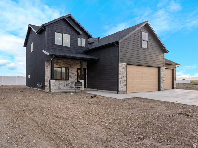 1267 West 2350 South Perry, UT 84302 - Photo 3 of 35 Contemporary two-story residence featuring dark siding and stone veneer accents