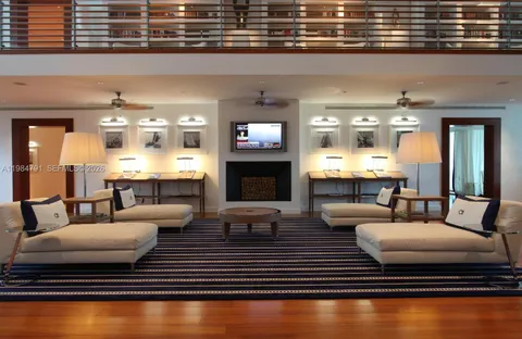 a living room with fireplace furniture and kitchen view