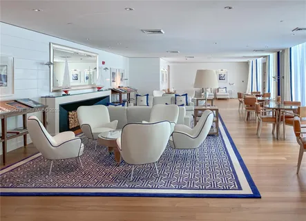 a living room with furniture a rug and a table