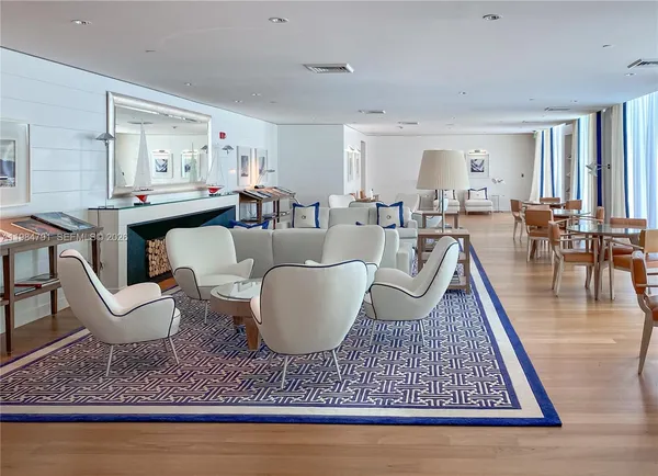 a living room with furniture a rug and a table