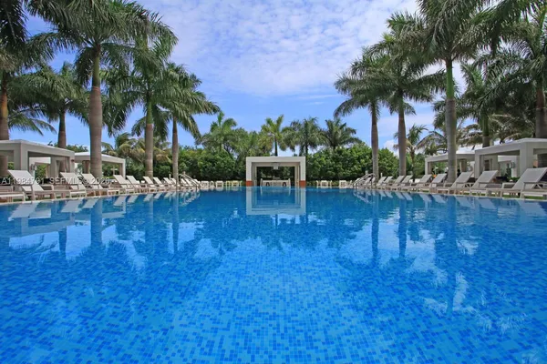 a swimming pool with outdoor seating and yard